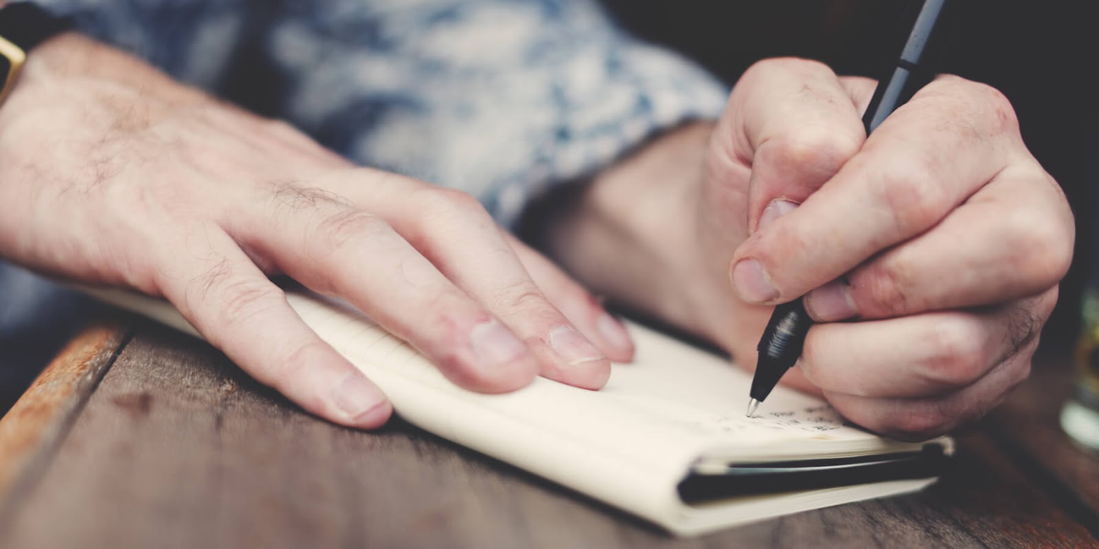 A person writing in a journal.