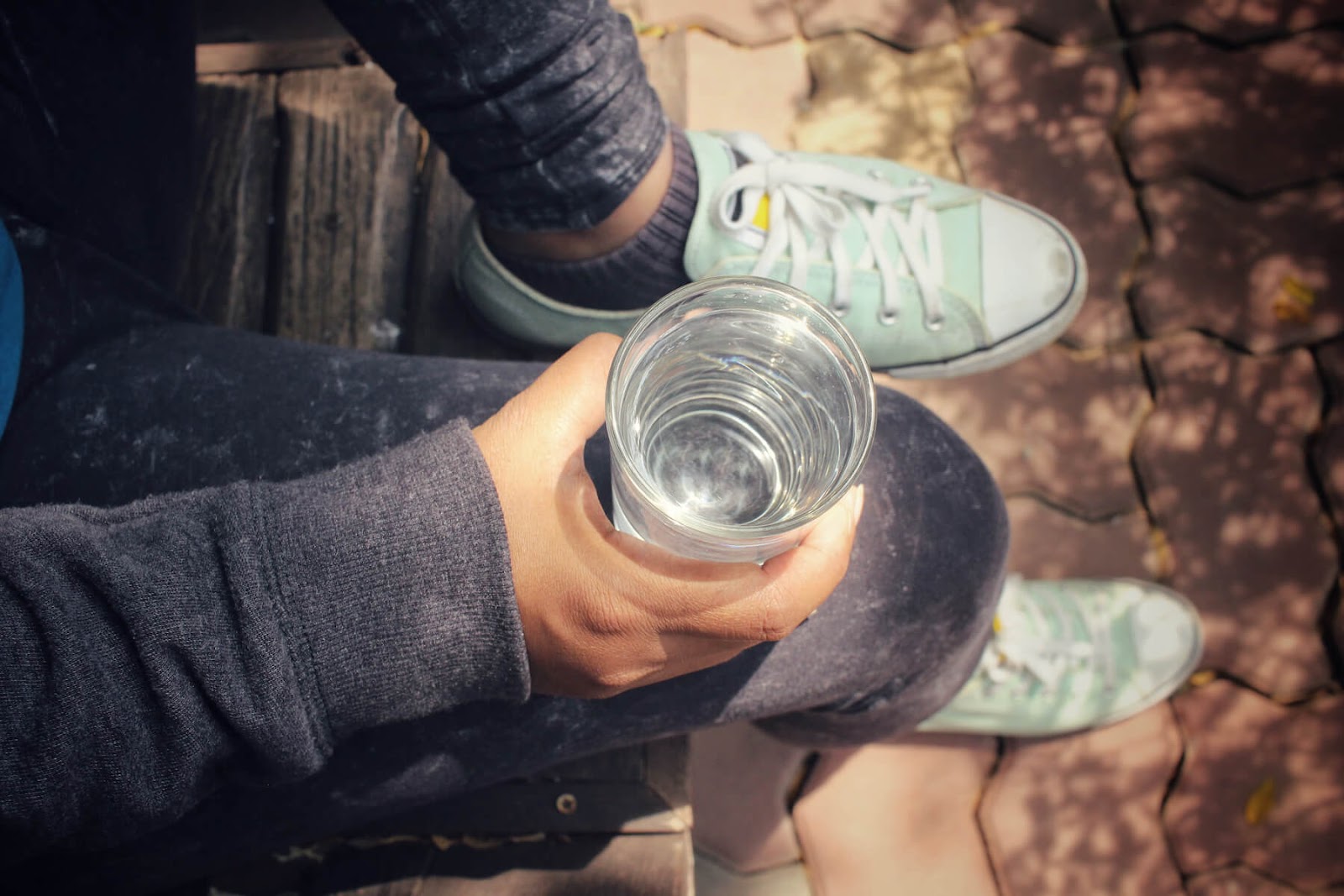A person drinking a glass of water.