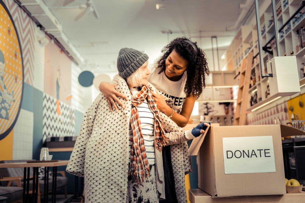 A person giving a coat away.