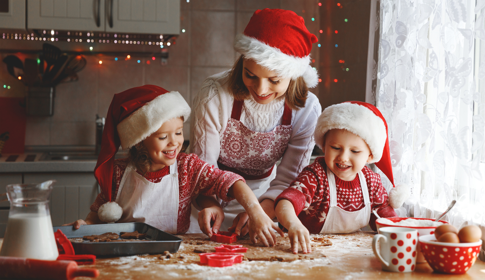 A family baking in Santa hats.