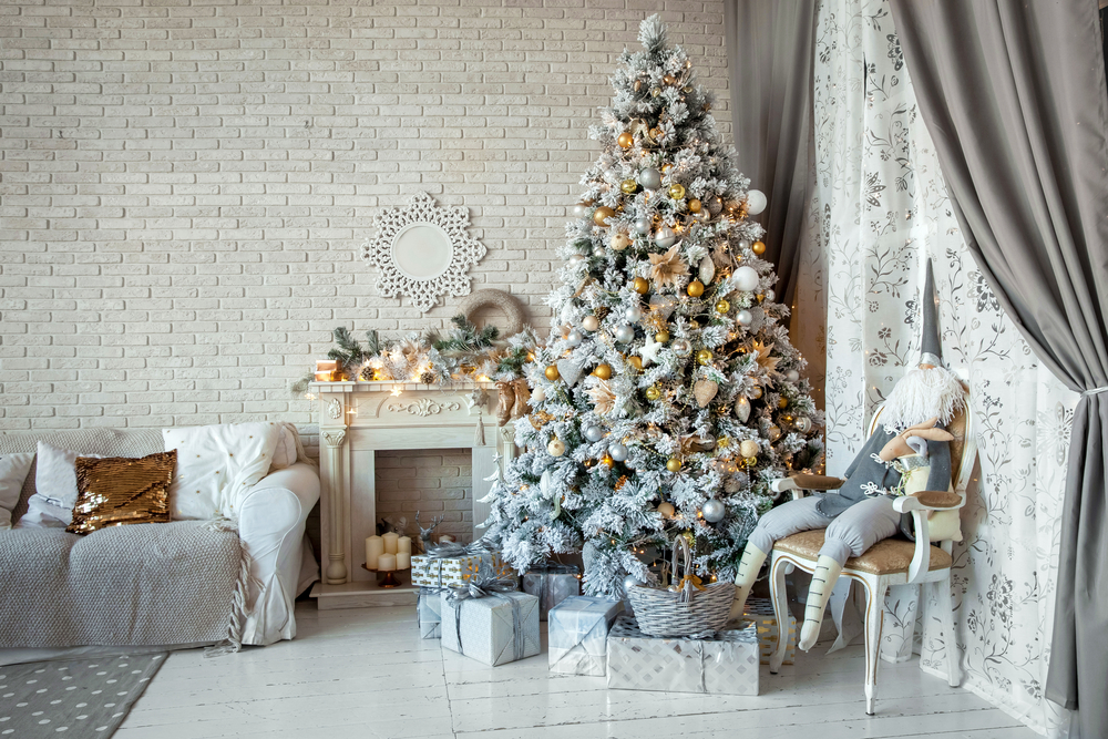 A living room with a white Christmas tree.