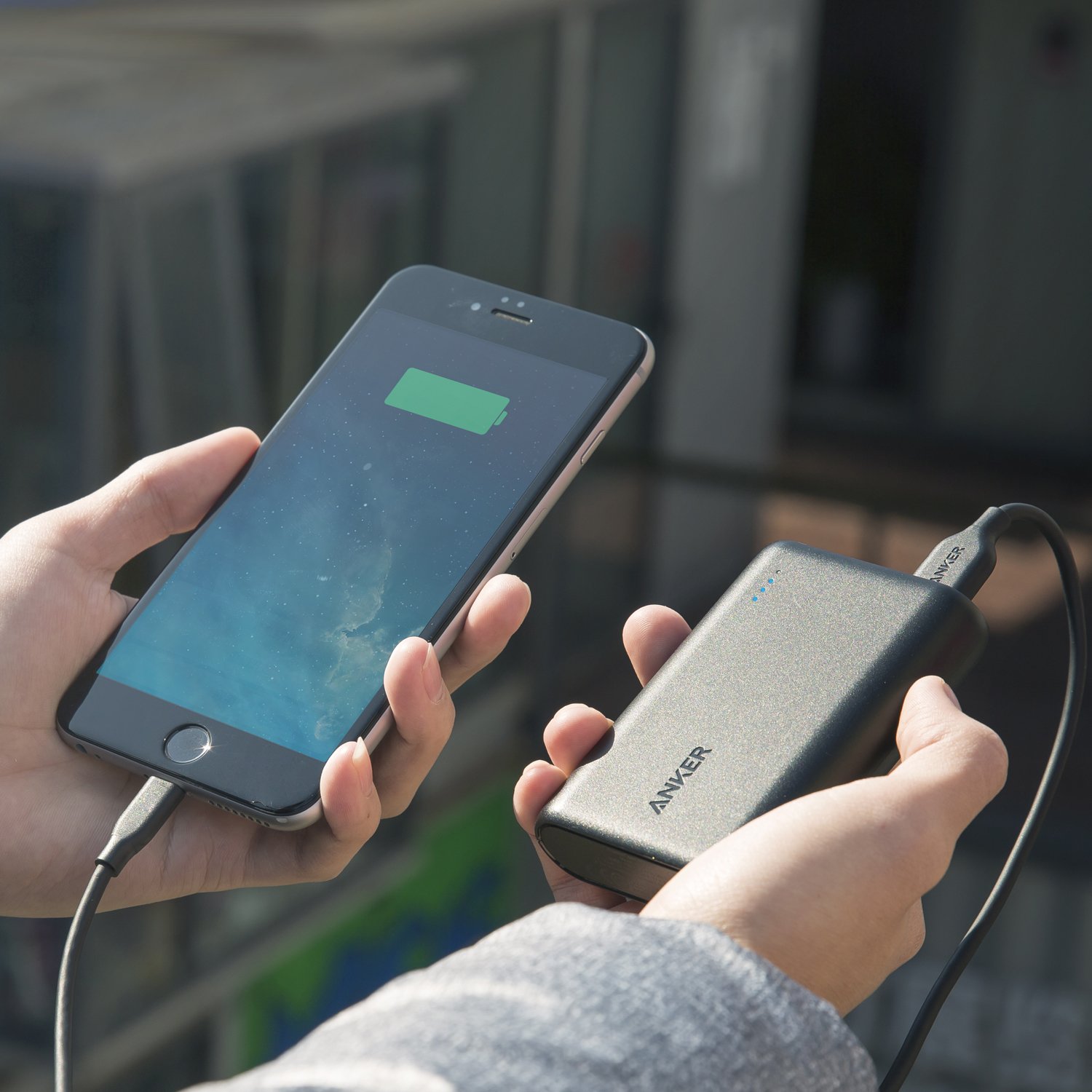An iPhone plugged into an Anker charger.