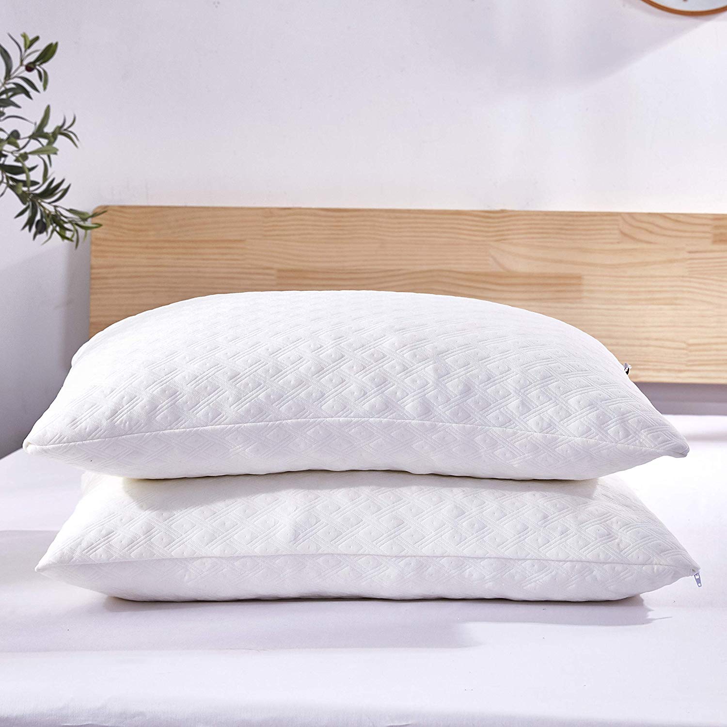 Two memory phone pillows on a bed.