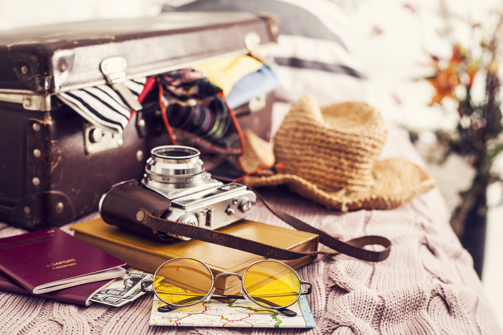 A camera, hat, and other travel gear.