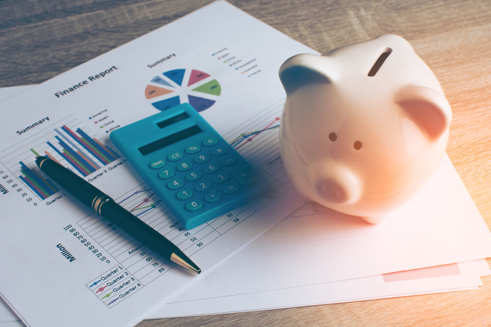 A person with a finance report planning their retirement savings.