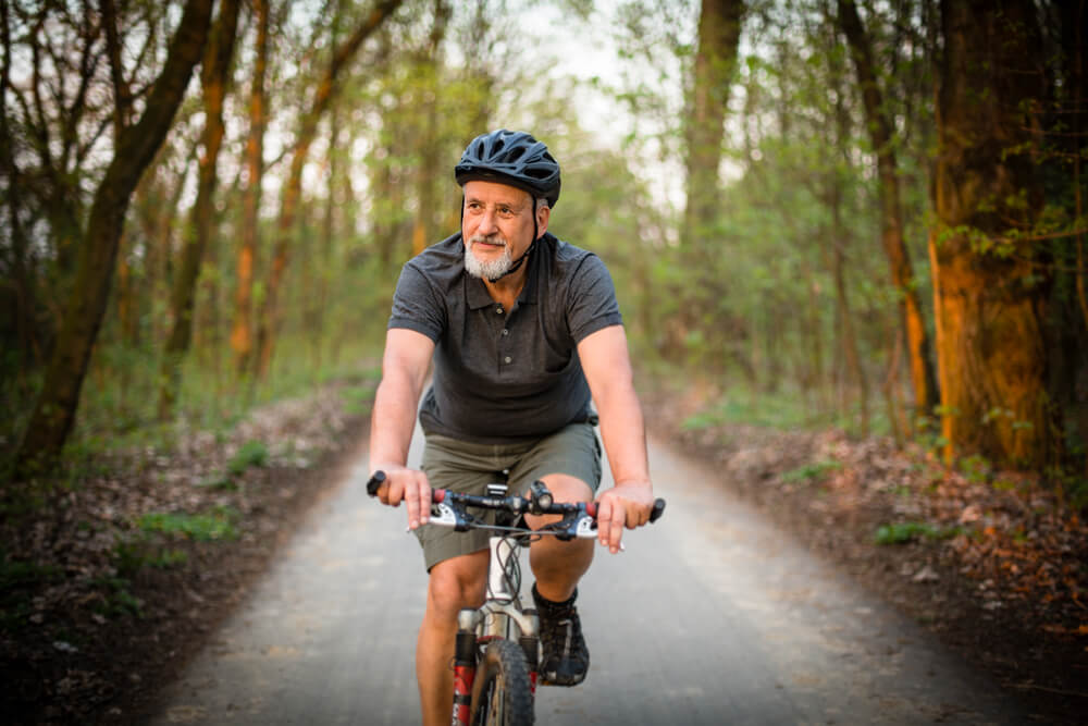 A man riding his bike thinking about income during retirement.