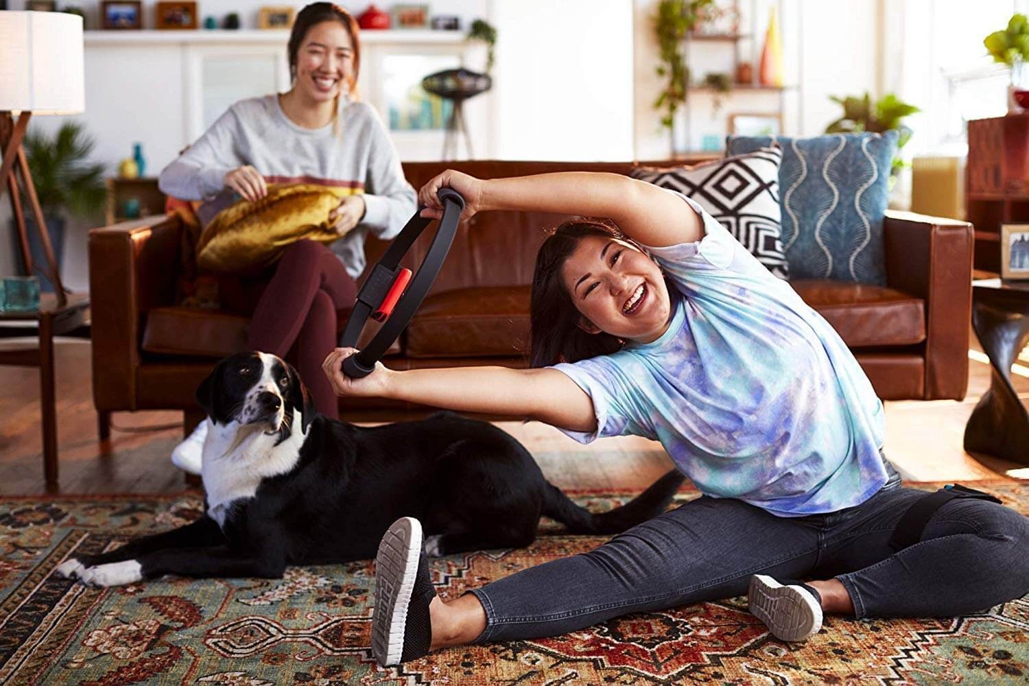 Two women playing with the Nintendo Ring Fit Adventure.