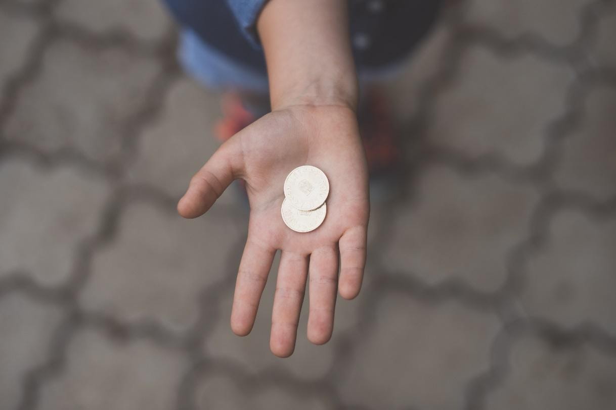 child with coin in hand