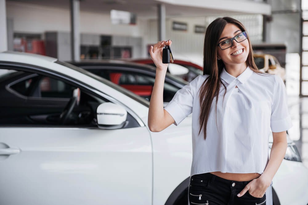 happy women with new car keys