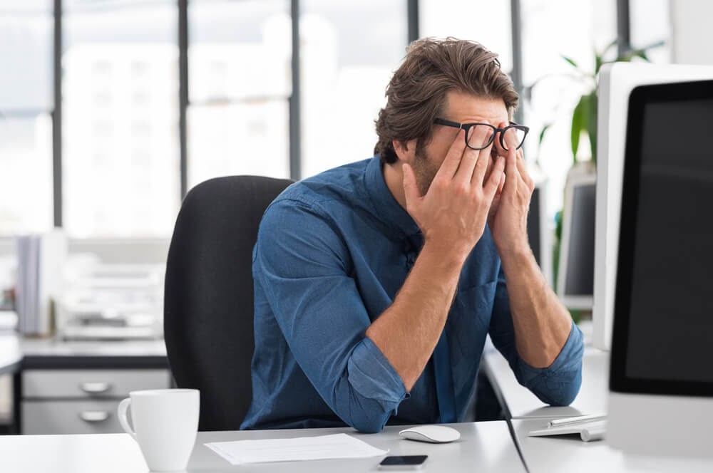 man straining his eyes