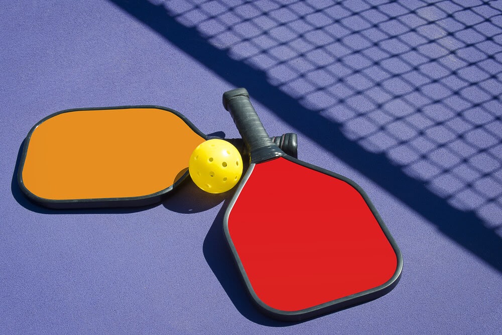 Read and orange Pickleball paddles with yellow ball