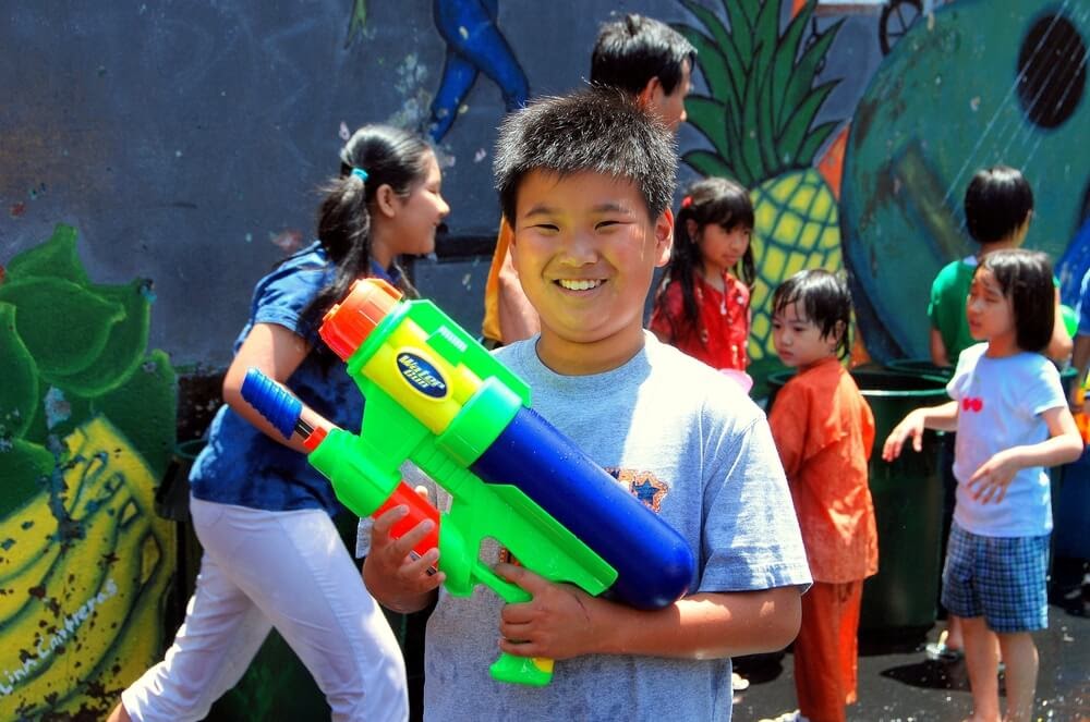Child holding large water gun