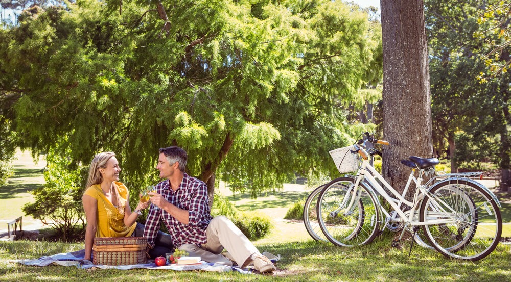 Couple sitting under a tree having a picnic
