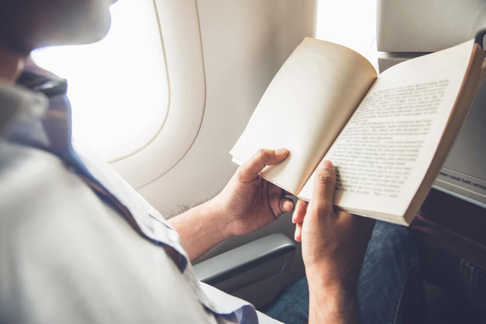 Person in airplane reading