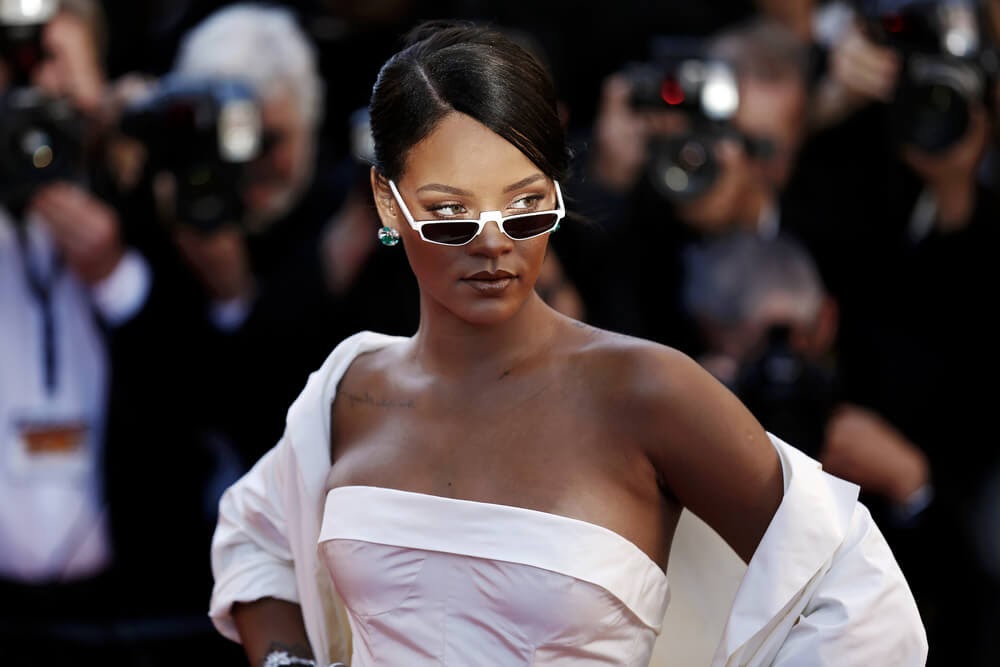 Rhianna wearing tiny white sunglasses