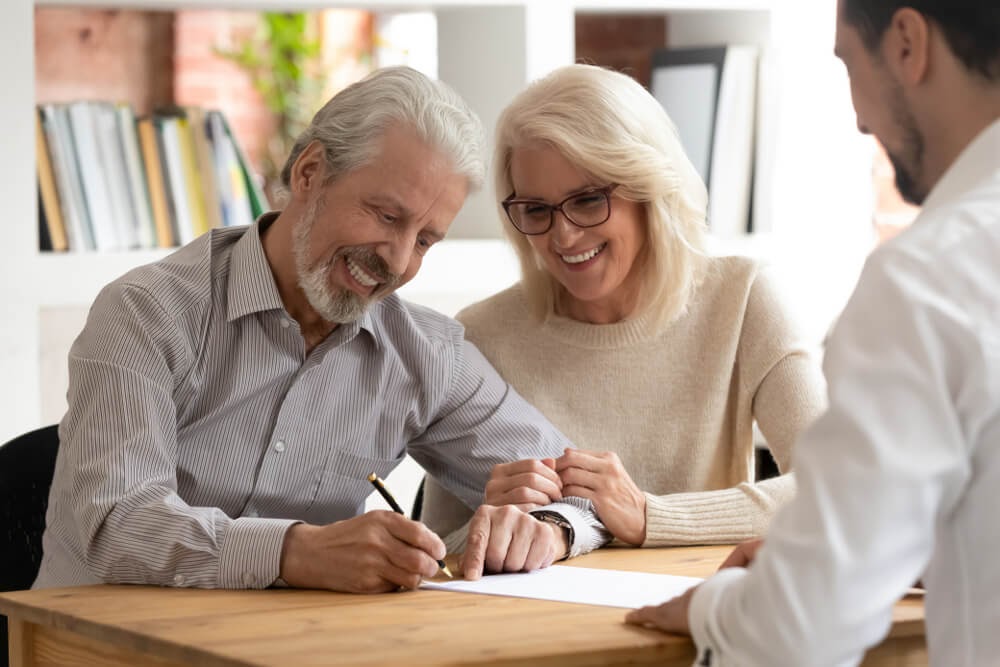 older couple signing paperwork
