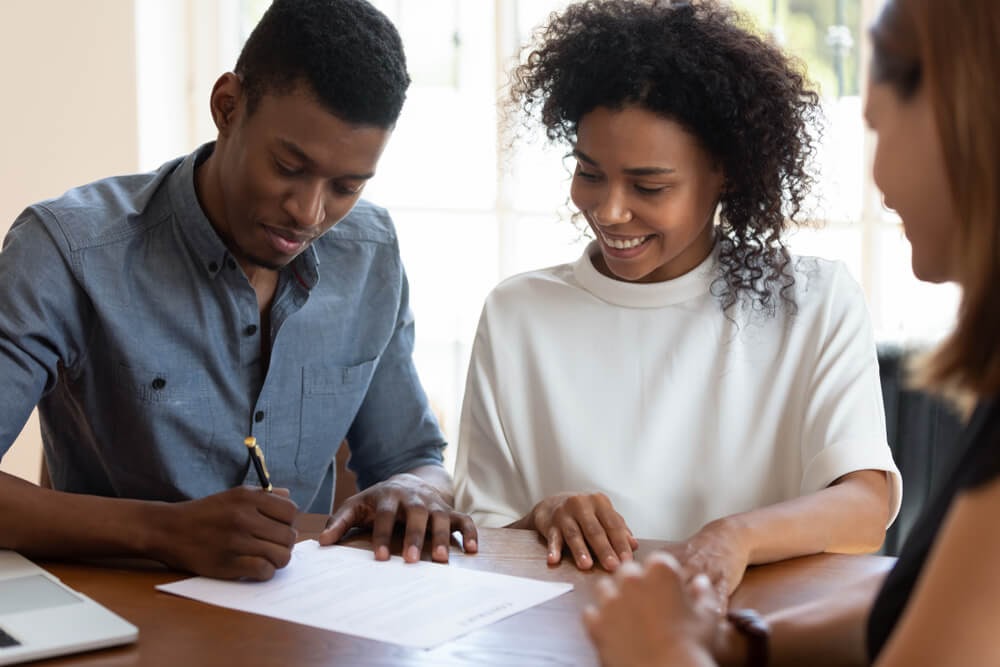 couple signing paperwork