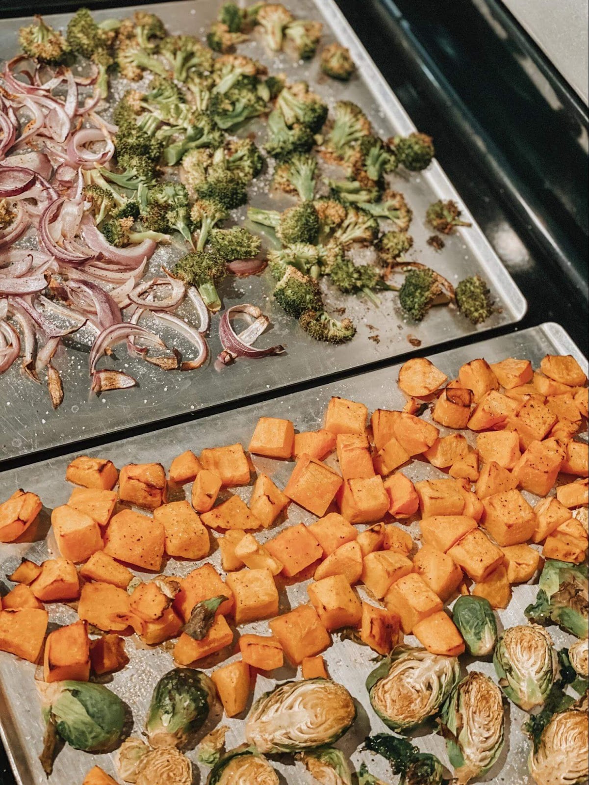 Photo of veggies roasting on a sheet pan