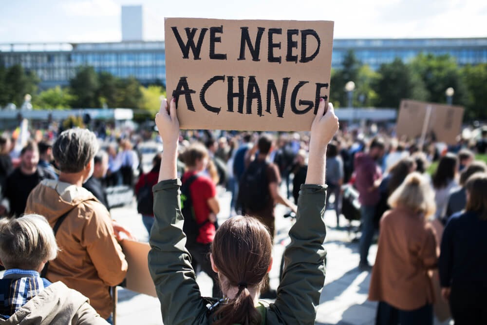 Sign depicting the words, "We Need A Change"