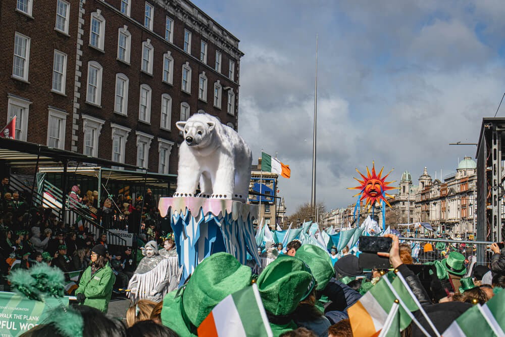 Parade in Dublin with float of polar bear on ice.
