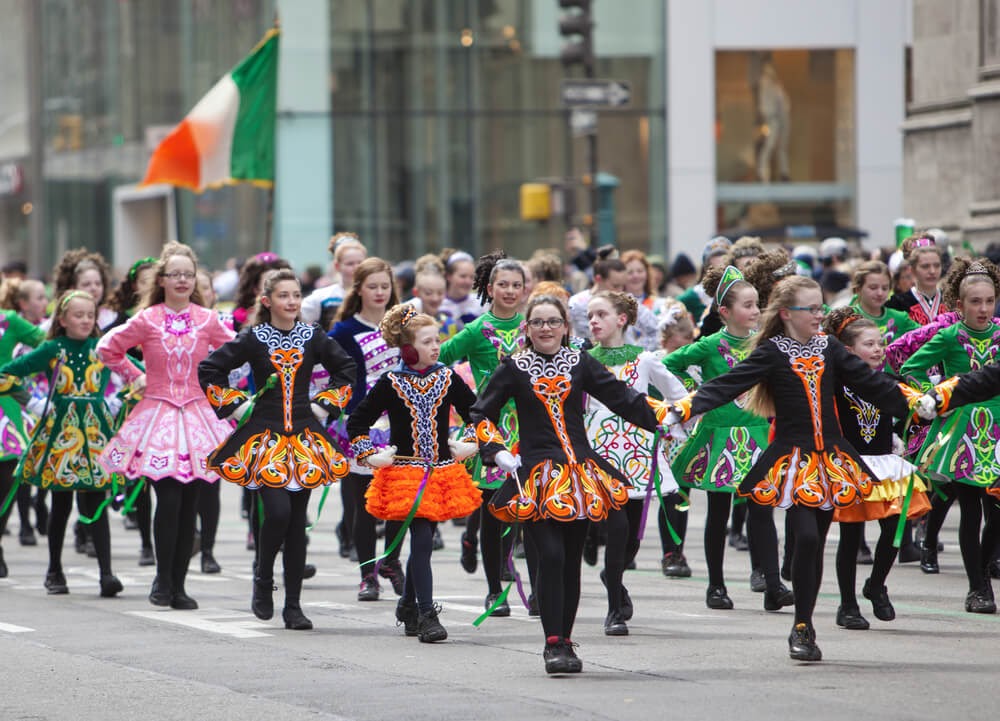 Young girls fill street in colorful Irish folk-dancing attire