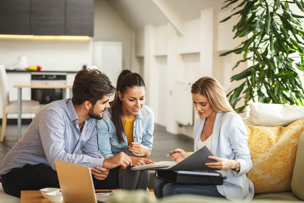 Three people looking over paperwork