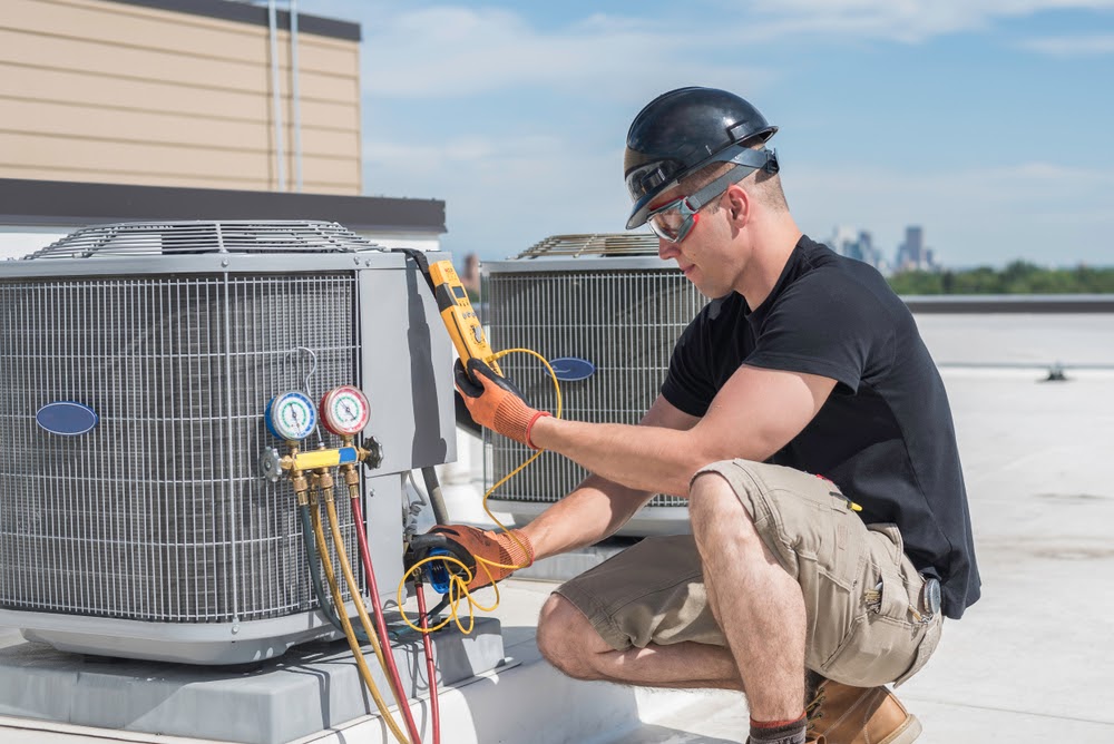 Technician repairing HVAC system