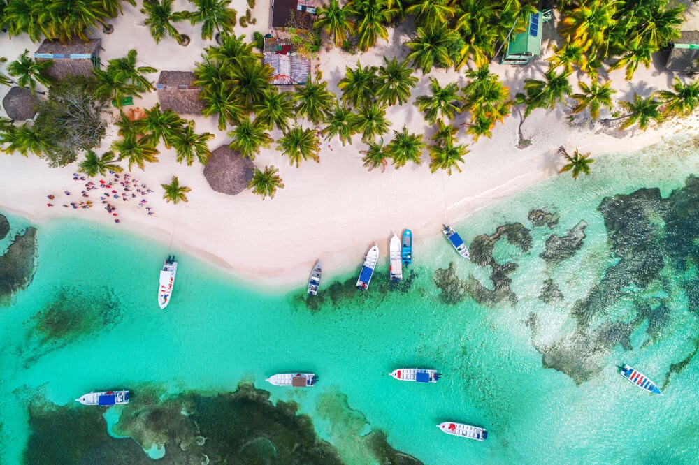 Turquoise water and white sand beach. Photo is taken from an arial view.