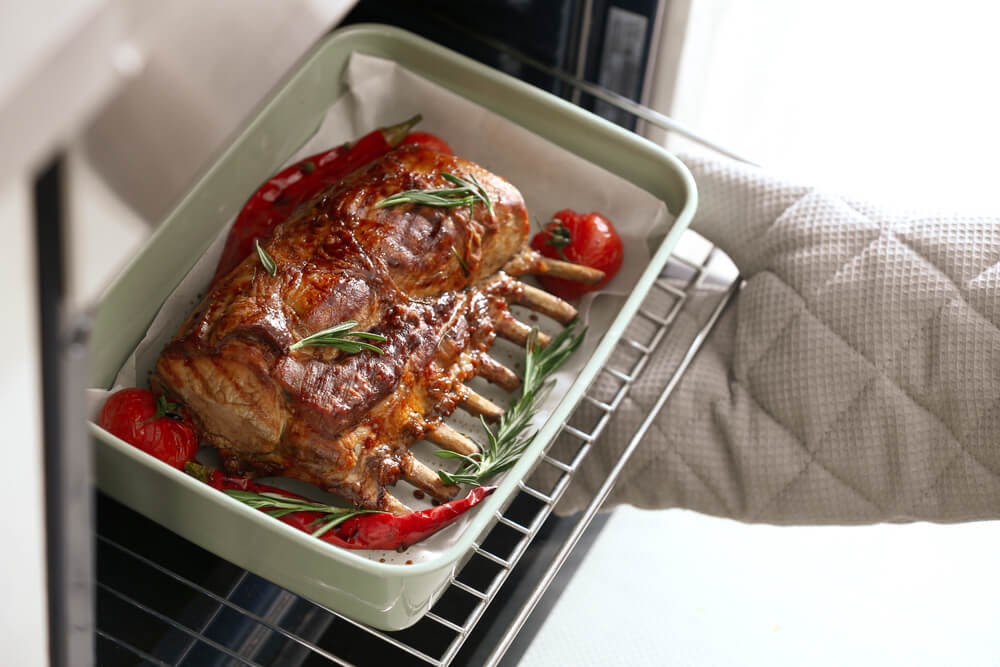 Pan of entire rack of lamb roasting