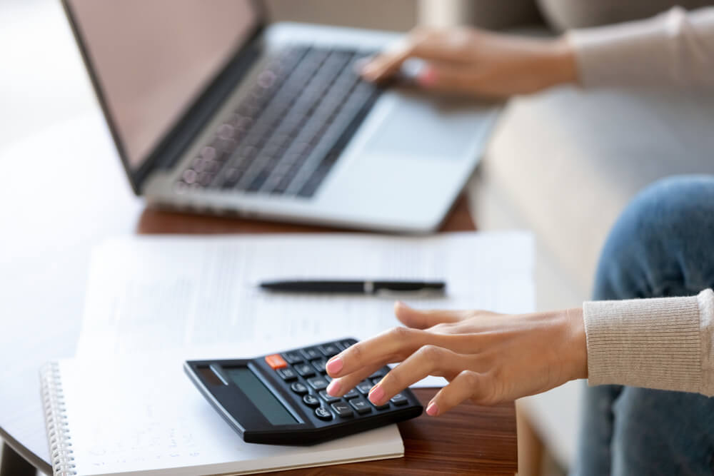 woman crunching numbers on calculator