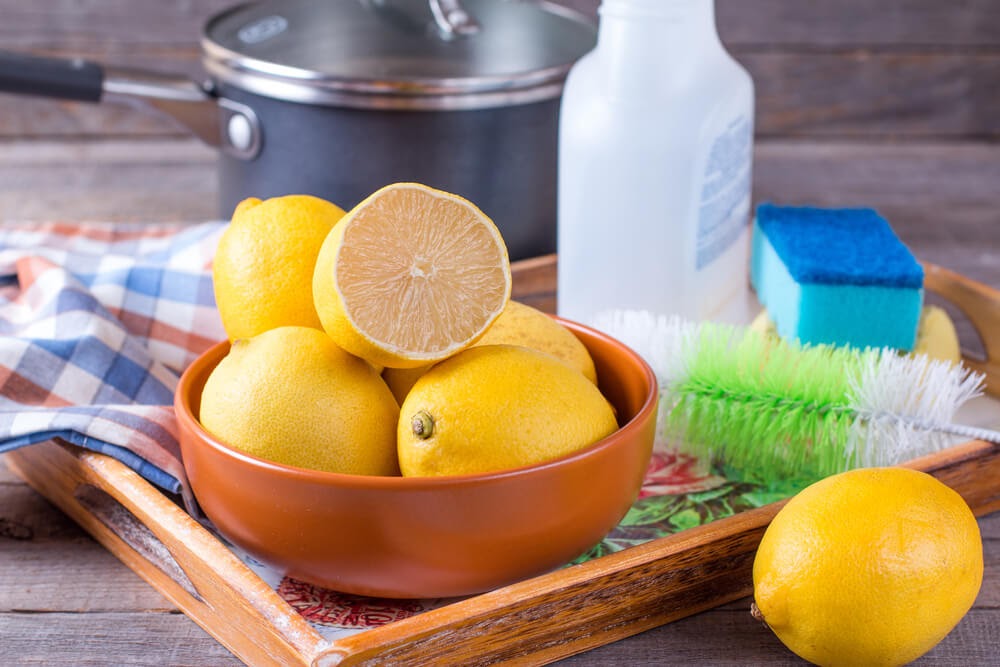 Bowl of lemons and cleaning tools.