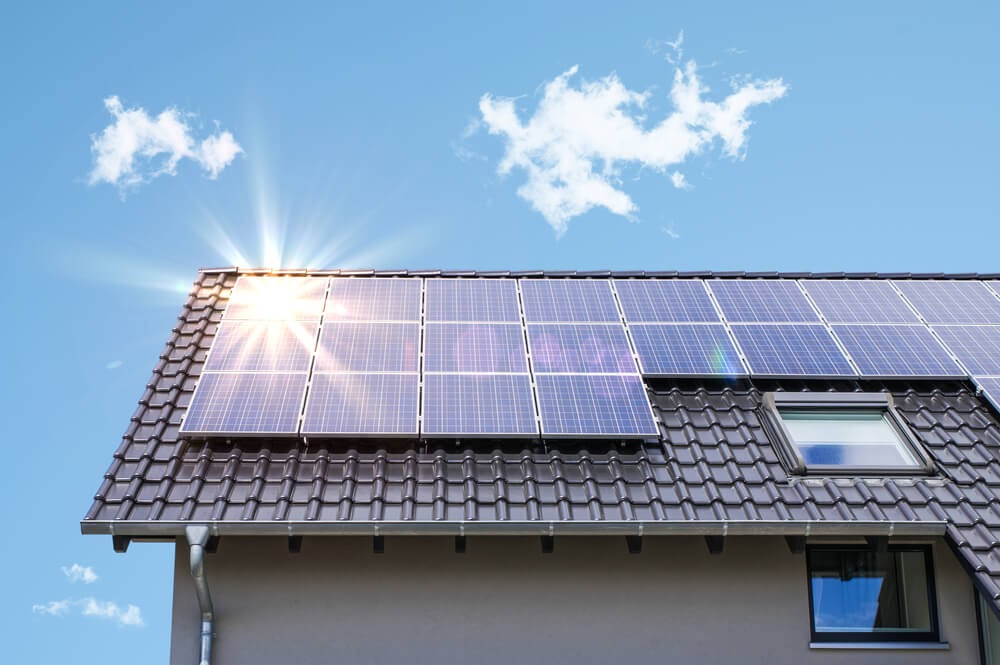 Roof with solar panels installed on a sunny day.