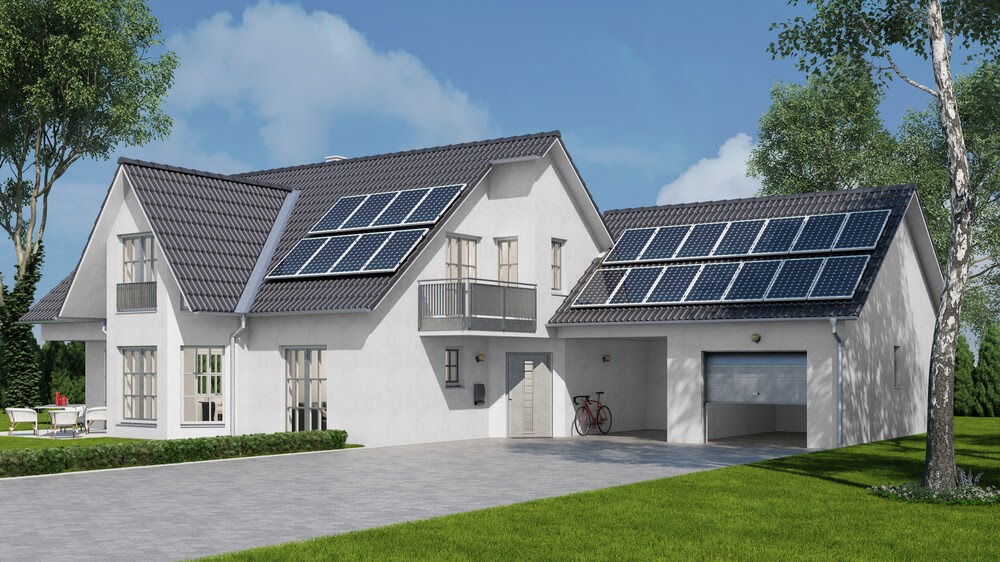 Large white home with solar panels on the roof.
