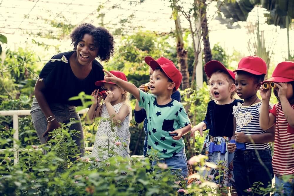 Kids looking at plants excitedly.