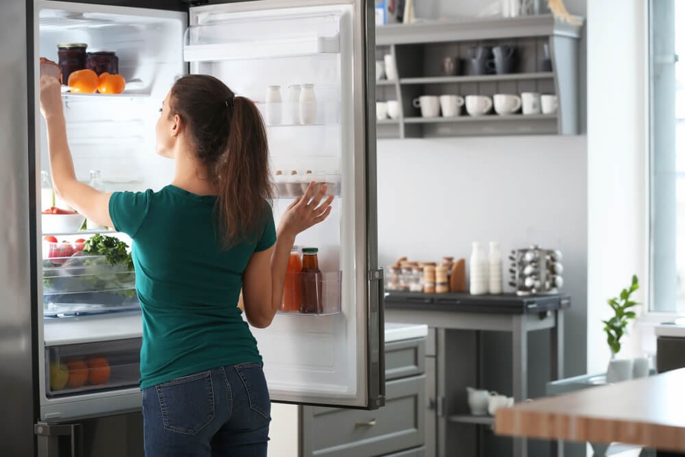Woman looking into fridge.
