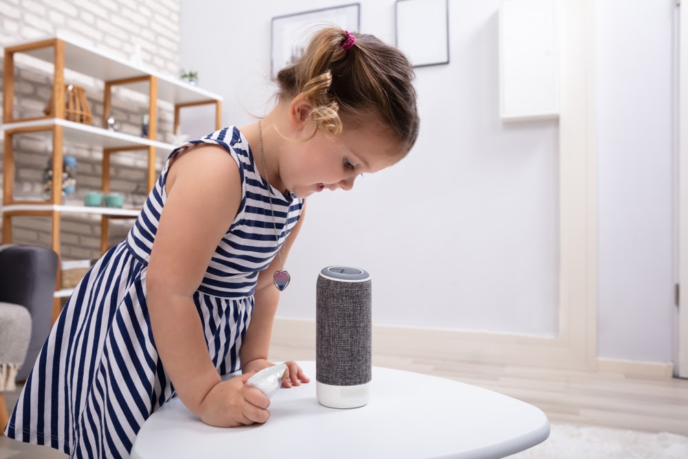 Child playing with bluetooth speaker.