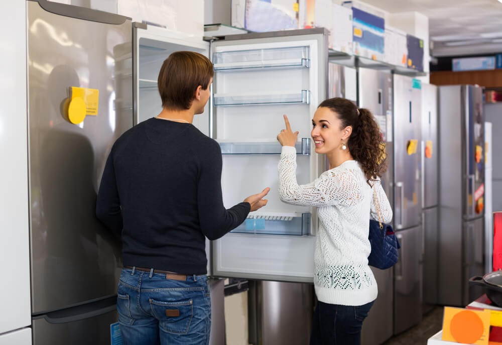 Couple shopping for a fridge.