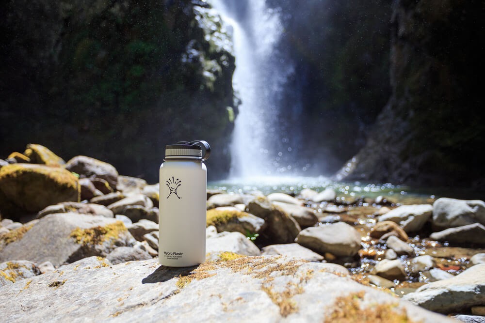 Hydroflask in front of a waterfall.