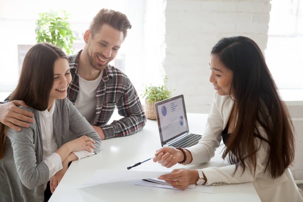 Man and woman reviewing papers with a consultant