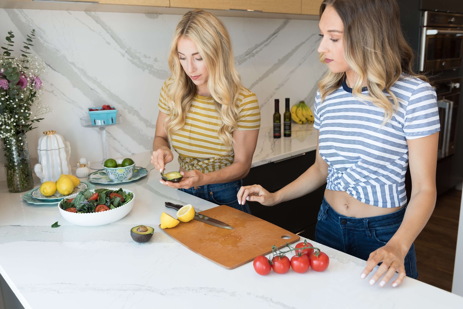 Two women prepping a salad