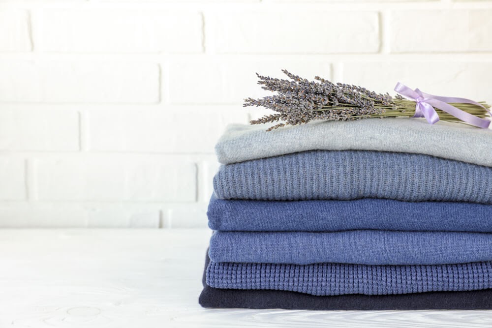 lavender bundle on pile of folded sweaters