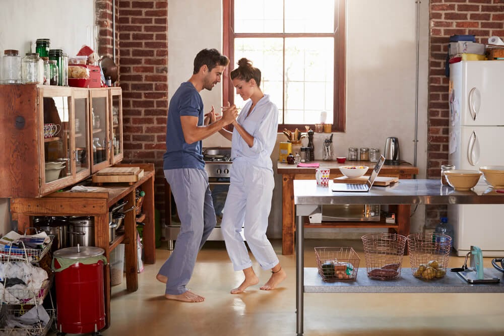 Man and woman dancing in their kitchen