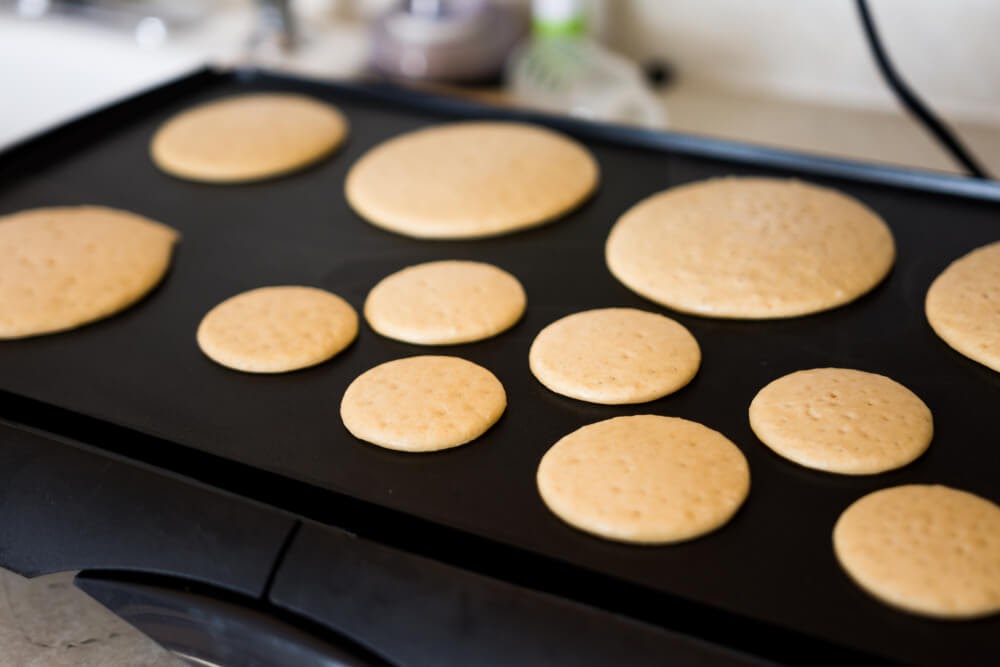 Griddle full of delicious but tiny pancakes