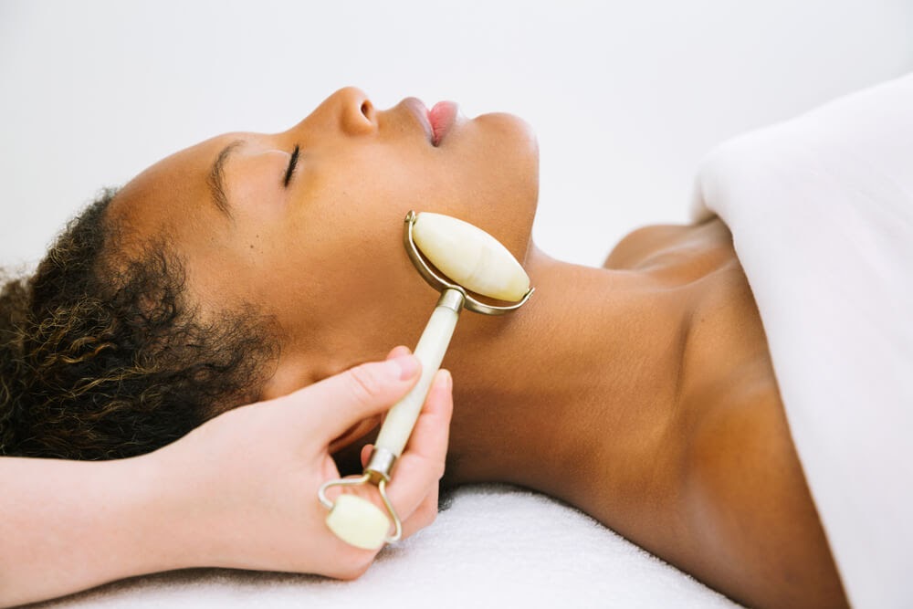 Woman at spa enjoying a jade roller