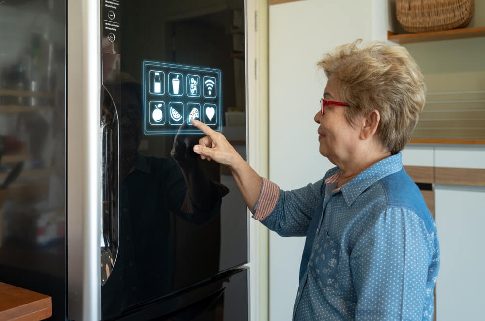 Woman finding food on her smart fridge door