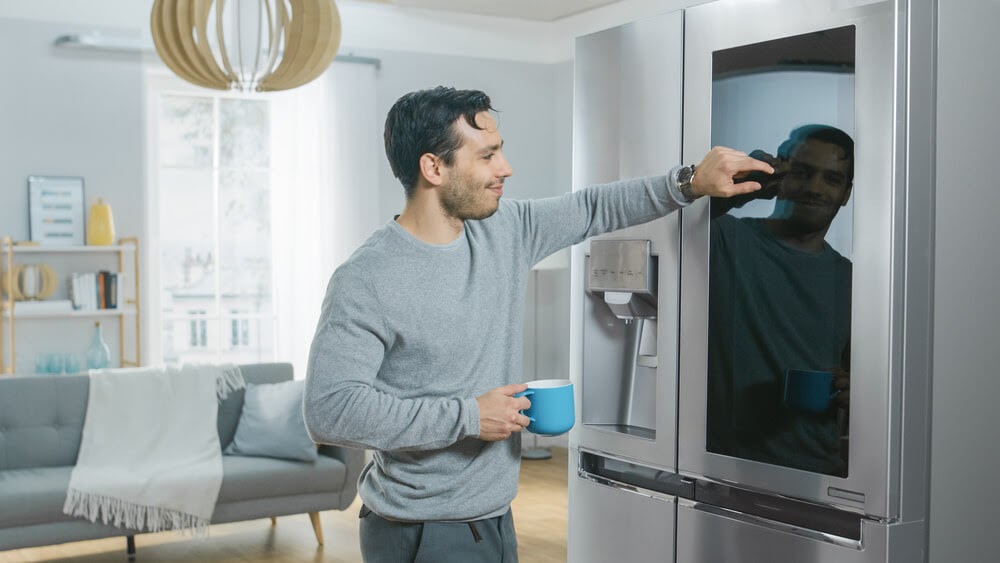 Man cleaning his smart fridge