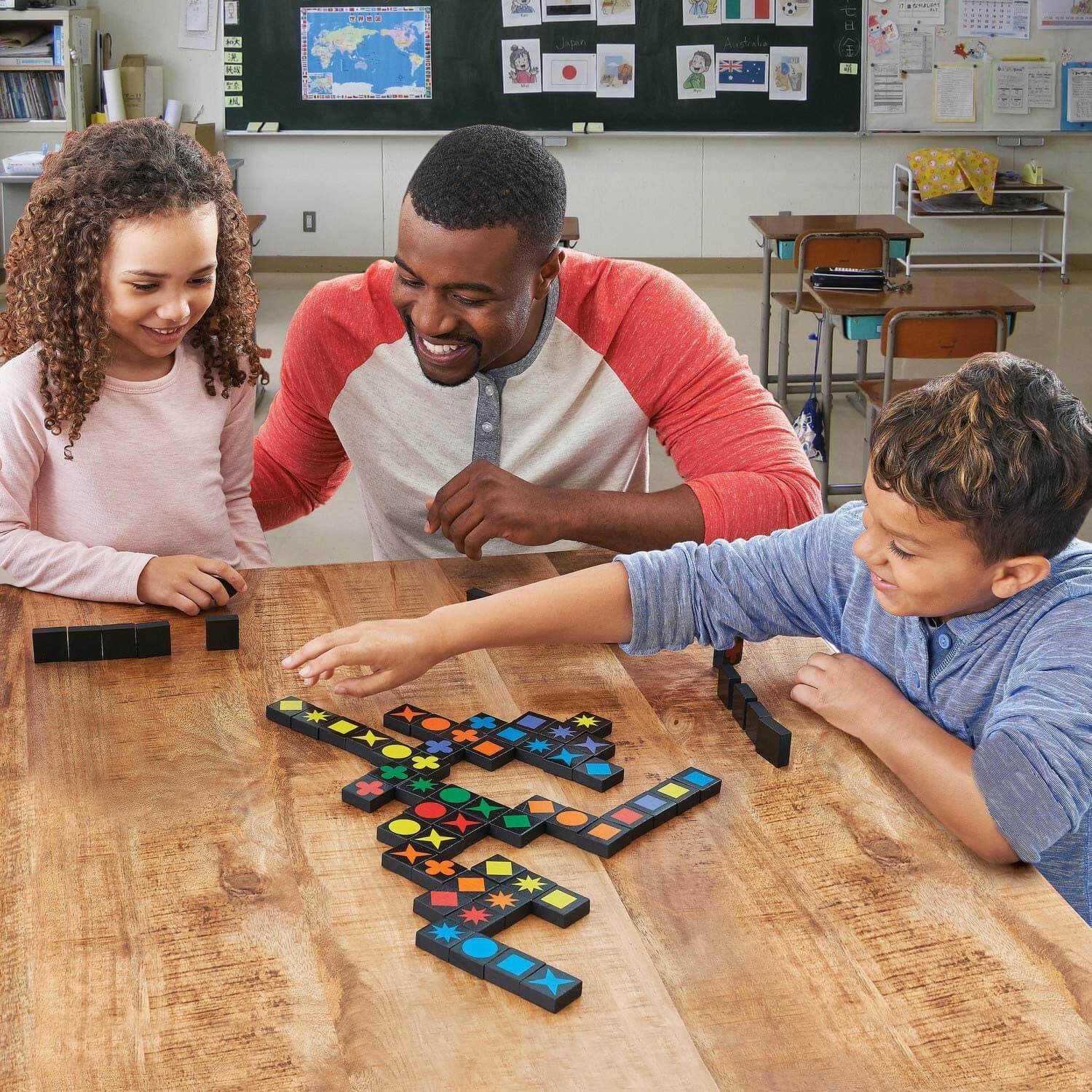 Teacher and two students playing dominoes