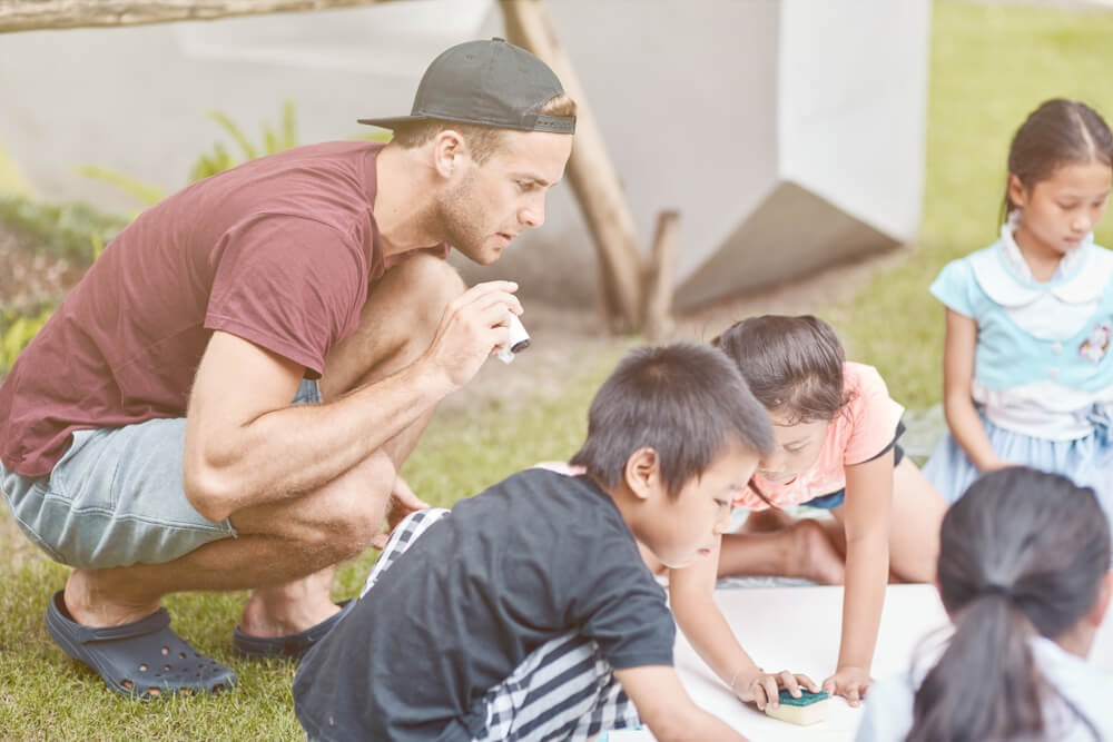 young professional volunteering with kids
