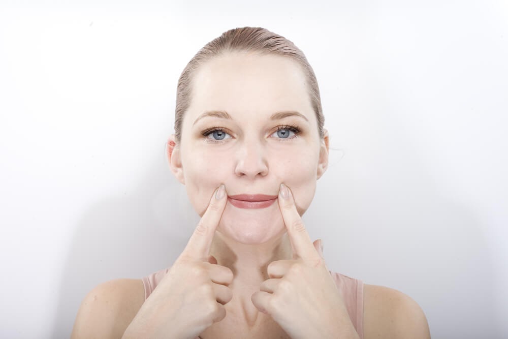 Woman pressing on the corners of her lips
