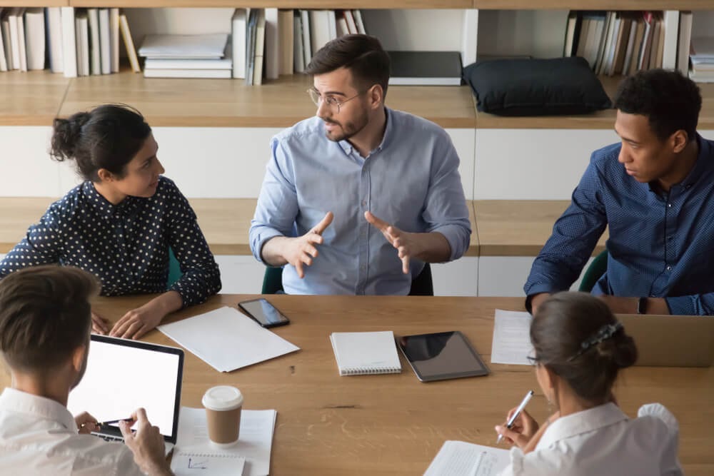 Men and women meeting around a table
